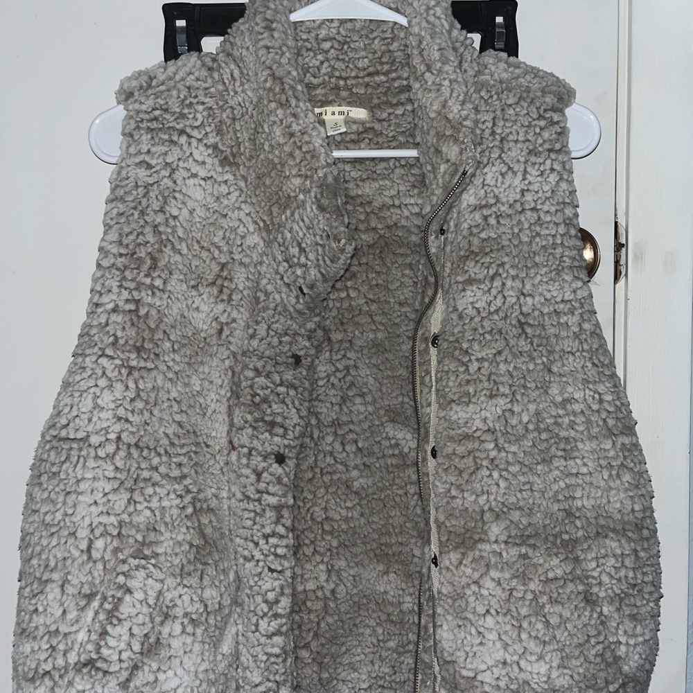 Fuzzy vest with zipper and buttons. Very cute and cozy!